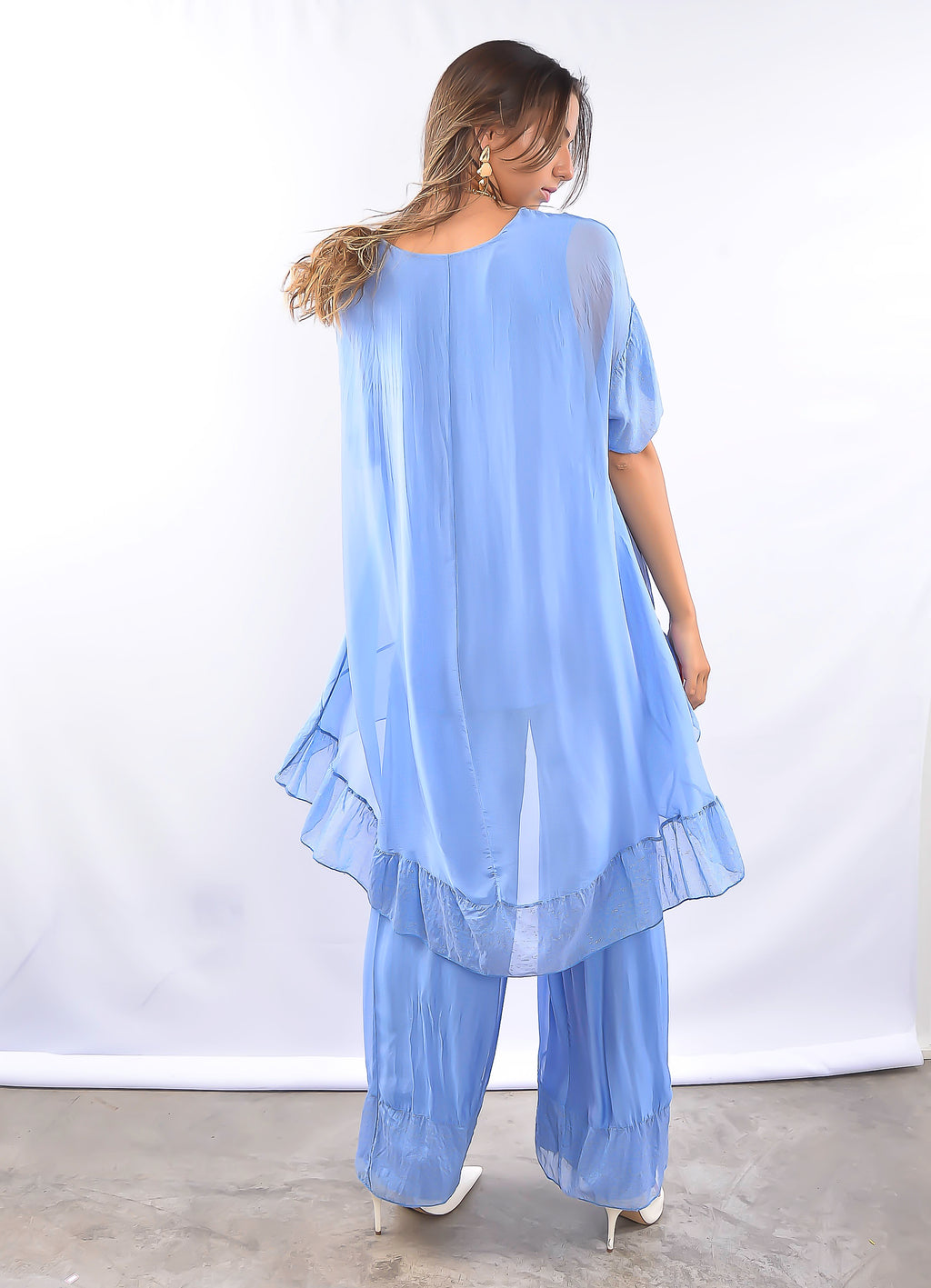 Modelo de costas usando conjunto azul leve e elegante.
