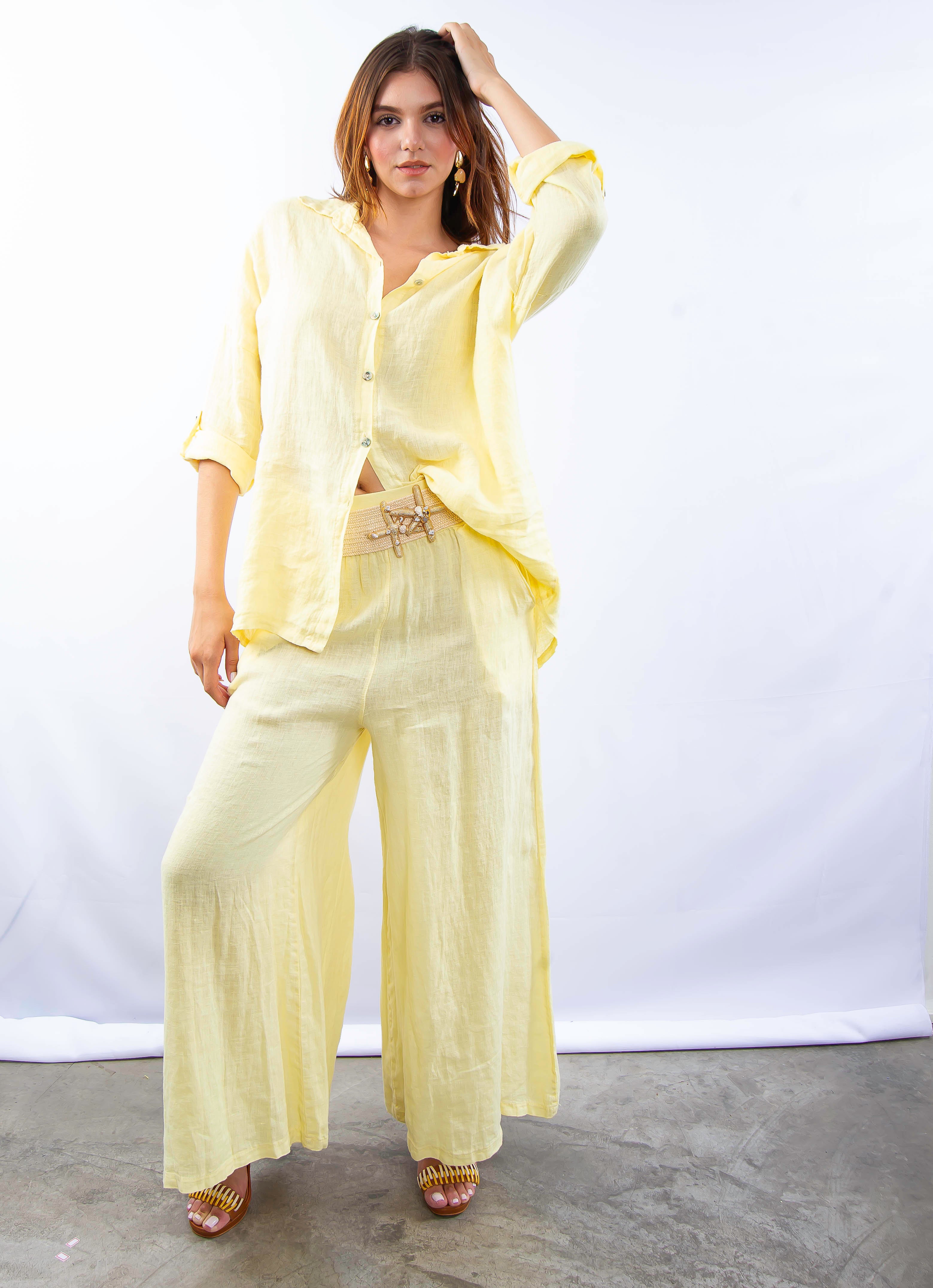 Conjunto de linho italiano amarelo em modelo feminina, ângulo lateral destacando a fluidez da peça